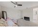 Bedroom featuring a ceiling fan, carpeted floor, and an adjacent bathroom at 336 Highland Shores Dr, Ellenton, FL 34222