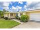 Bright exterior showcasing a well-maintained yard and blue front door at 336 Highland Shores Dr, Ellenton, FL 34222