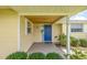 A welcoming front porch, featuring a stylish blue door and lovely landscaping at 336 Highland Shores Dr, Ellenton, FL 34222
