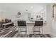 Bright kitchen with gray cabinets, stainless steel refrigerator, breakfast bar, and wood-look flooring at 336 Highland Shores Dr, Ellenton, FL 34222