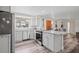 Open kitchen showcasing gray cabinetry, stainless steel appliances, bar seating, and modern lighting at 336 Highland Shores Dr, Ellenton, FL 34222