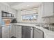 Close up of the kitchen area featuring a stainless sink, gray cabinets, and modern countertops at 336 Highland Shores Dr, Ellenton, FL 34222