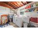 Practical laundry room with a washer, dryer, utility sink, and ample shelving for storage at 336 Highland Shores Dr, Ellenton, FL 34222