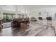Open-concept living space with wood-look floors, comfortable seating, and open access to other areas at 336 Highland Shores Dr, Ellenton, FL 34222