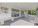 Enclosed patio featuring outdoor seating and screened windows, perfect for enjoying the outdoors at 336 Highland Shores Dr, Ellenton, FL 34222