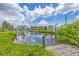 Beautiful waterfront view from the wooden dock, surrounded by lush greenery and serene water reflections at 336 Highland Shores Dr, Ellenton, FL 34222
