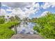 Picturesque waterfront view from a wooden dock with vibrant green foliage along the canal at 336 Highland Shores Dr, Ellenton, FL 34222