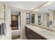 Bathroom with double sinks and a view into the bedroom at 3658 Torrey Pines Way, Sarasota, FL 34238