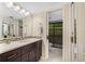 Bathroom with a sink, dark cabinets, and a toilet behind a door at 3658 Torrey Pines Way, Sarasota, FL 34238