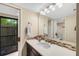Bathroom with a sink and decorative tile backsplash, and an adjacent door to the patio at 3658 Torrey Pines Way, Sarasota, FL 34238