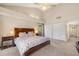 Spacious carpeted bedroom features a vaulted ceiling with fan, and large closets with an attached bathroom at 3658 Torrey Pines Way, Sarasota, FL 34238