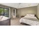 Carpeted bedroom shows open door to closet and view of outdoors through sliding glass door at 3658 Torrey Pines Way, Sarasota, FL 34238