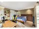 Relaxing bedroom includes a desk and bookshelf with a window view at 3658 Torrey Pines Way, Sarasota, FL 34238