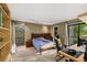 Bright bedroom with desk and bookshelf has a slider door to the exterior. It also features a walk-in closet at 3658 Torrey Pines Way, Sarasota, FL 34238