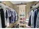 This closet is organized with lots of clothes, shoes and hats. There are shelves and hanging racks for storage at 3658 Torrey Pines Way, Sarasota, FL 34238