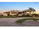 Sarasota Sports Club clubhouse featuring a porte-cochere and manicured landscaping at 3658 Torrey Pines Way, Sarasota, FL 34238