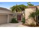 Attractive covered entry with double doors surrounded by lush, mature landscaping at 3658 Torrey Pines Way, Sarasota, FL 34238