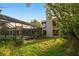 An exterior view of the home featuring the backyard and pool area at 3658 Torrey Pines Way, Sarasota, FL 34238