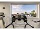 View from a treadmill in the gym, showcasing the outdoor scenery and a glimpse of the community at 3658 Torrey Pines Way, Sarasota, FL 34238