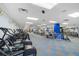 A fully equipped gym featuring a variety of cardio and strength training equipment, set in a spacious layout at 3658 Torrey Pines Way, Sarasota, FL 34238