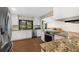 Updated kitchen with stainless steel appliances, granite counters and ample cabinet space at 3658 Torrey Pines Way, Sarasota, FL 34238