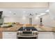 Bright kitchen with a granite countertop island and stainless steel appliances at 3658 Torrey Pines Way, Sarasota, FL 34238