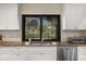 Bright and modern kitchen with granite counters, white cabinets and stainless steel appliances at 3658 Torrey Pines Way, Sarasota, FL 34238