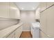 Laundry room features ample cabinet space and a utility sink at 3658 Torrey Pines Way, Sarasota, FL 34238