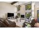 Cozy living room with high ceilings, fireplace and plentiful natural light at 3658 Torrey Pines Way, Sarasota, FL 34238