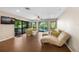 Cozy living room with tile flooring, sliding glass doors to the pool, and comfortable seating at 3658 Torrey Pines Way, Sarasota, FL 34238
