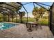 A large patio with brick pavers featuring a table and chairs with scenic outdoor views at 3658 Torrey Pines Way, Sarasota, FL 34238