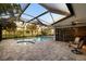 Enclosed outdoor pool area with hot tub offers picturesque golf course views and outdoor seating at 3658 Torrey Pines Way, Sarasota, FL 34238
