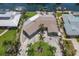 Aerial view of property showcasing circular driveway, lush landscaping, and canal access at 3715 Bamboo Ter, Bradenton, FL 34210