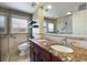 Updated bathroom with double vanity, granite countertops, tiled walls, and walk-in shower at 3715 Bamboo Ter, Bradenton, FL 34210
