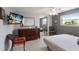Bedroom with a TV, dresser, large mirror, ceiling fan, and modern decor at 3715 Bamboo Ter, Bradenton, FL 34210