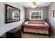 Bedroom with a black metal bed frame, bedside table, and large mirror on the wall with a window view at 3715 Bamboo Ter, Bradenton, FL 34210