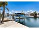 View of boat lift with boat, canal, and lush landscaping, offering a serene setting at 3715 Bamboo Ter, Bradenton, FL 34210
