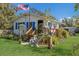 Charming, quaint cottage with blue shutters, wood porch, and American flag. In Cortez Cultural Center at 3715 Bamboo Ter, Bradenton, FL 34210