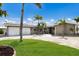 Charming single-story home featuring a well-manicured lawn, palm trees, and a spacious driveway at 3715 Bamboo Ter, Bradenton, FL 34210