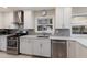 Updated kitchen featuring stainless steel appliances, a gray backsplash, window with view, and modern cabinetry at 3715 Bamboo Ter, Bradenton, FL 34210