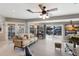 Bright living room with tile floors, fan, and sliding glass doors overlooking the water at 3715 Bamboo Ter, Bradenton, FL 34210
