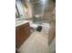 Tiled bathroom features a sink vanity, tiled bathtub and shower, and a neutral color scheme at 3806 Gulf Of Mexico Dr # C205, Longboat Key, FL 34228