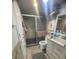 Tiled bathroom includes a glass door shower, tiled floors, and a white vanity at 3806 Gulf Of Mexico Dr # C205, Longboat Key, FL 34228
