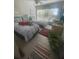 Bright bedroom features two twin beds, ceiling fan, and large window overlooking lush greenery at 3806 Gulf Of Mexico Dr # C205, Longboat Key, FL 34228