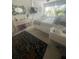 Well-lit bedroom showcasing nice interior details including a vanity and mounted TV at 3806 Gulf Of Mexico Dr # C205, Longboat Key, FL 34228