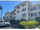 Inviting condo building surrounded by manicured landscaping, enhancing curb appeal at 3806 Gulf Of Mexico Dr # C205, Longboat Key, FL 34228