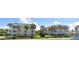 Beach Harbor Club condos amidst lush landscaping, offering serene coastal living with blue rooftops at 3806 Gulf Of Mexico Dr # C205, Longboat Key, FL 34228