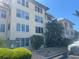 Three story exterior showing mature landscape and meticulous maintenance at 3806 Gulf Of Mexico Dr # C205, Longboat Key, FL 34228