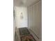 Narrow hallway featuring carpet flooring and white doors, offering storage space at 3806 Gulf Of Mexico Dr # C205, Longboat Key, FL 34228