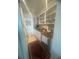 Galley kitchen with white cabinets, marble countertops, and open shelving for a modern look at 3806 Gulf Of Mexico Dr # C205, Longboat Key, FL 34228